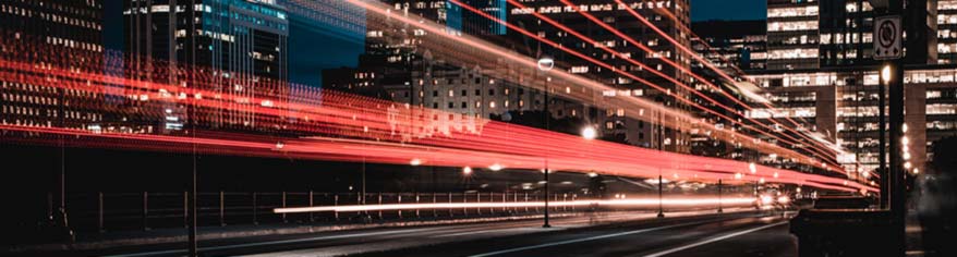 long exposure lights in moving fast in a cityscape